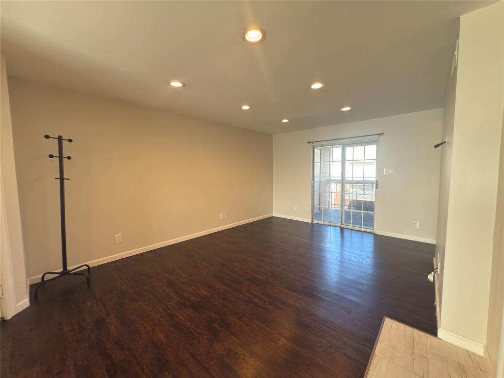 12480 Abrams Road, Unit 2922 Dallas, TX 75243 - Photo 12 of 25 a view of empty room with wooden floor and fan