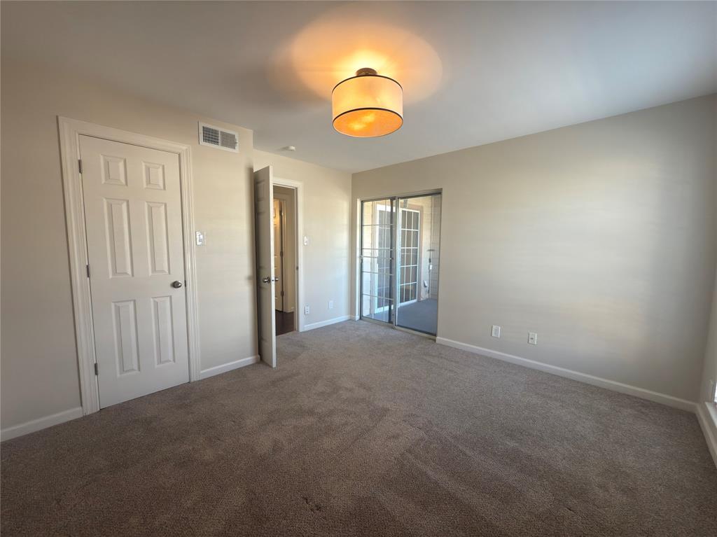 12480 Abrams Road, Unit 2922 Dallas, TX 75243 - Photo 14 of 25 an empty room with a chandelier fan and a window