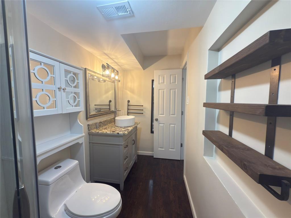 12480 Abrams Road, Unit 2922 Dallas, TX 75243 - Photo 18 of 25 a bathroom with a toilet sink and a large mirror