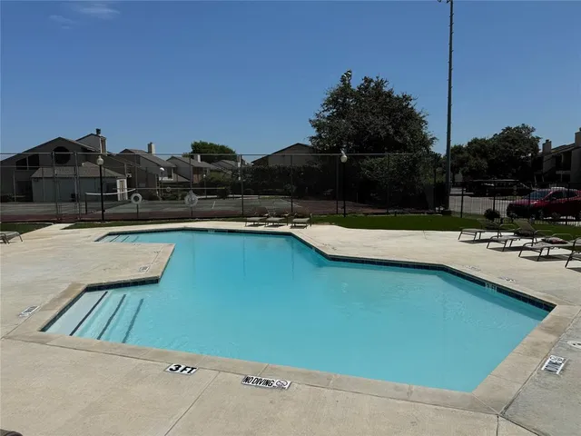 a view of a swimming pool and lounge chair