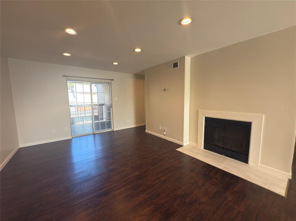 12480 Abrams Road, Unit 2922 Dallas, TX 75243 - Photo 5 of 25 an empty room with wooden floor and windows
