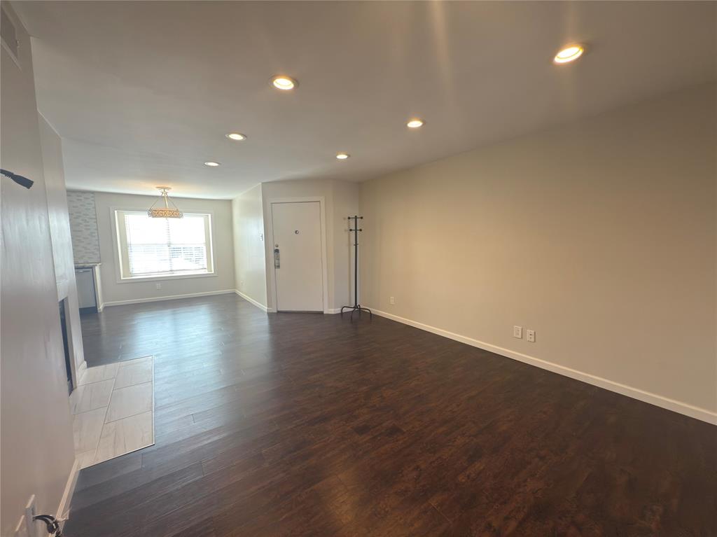 12480 Abrams Road, Unit 2922 Dallas, TX 75243 - Photo 7 of 25 an empty room with wooden floor and windows
