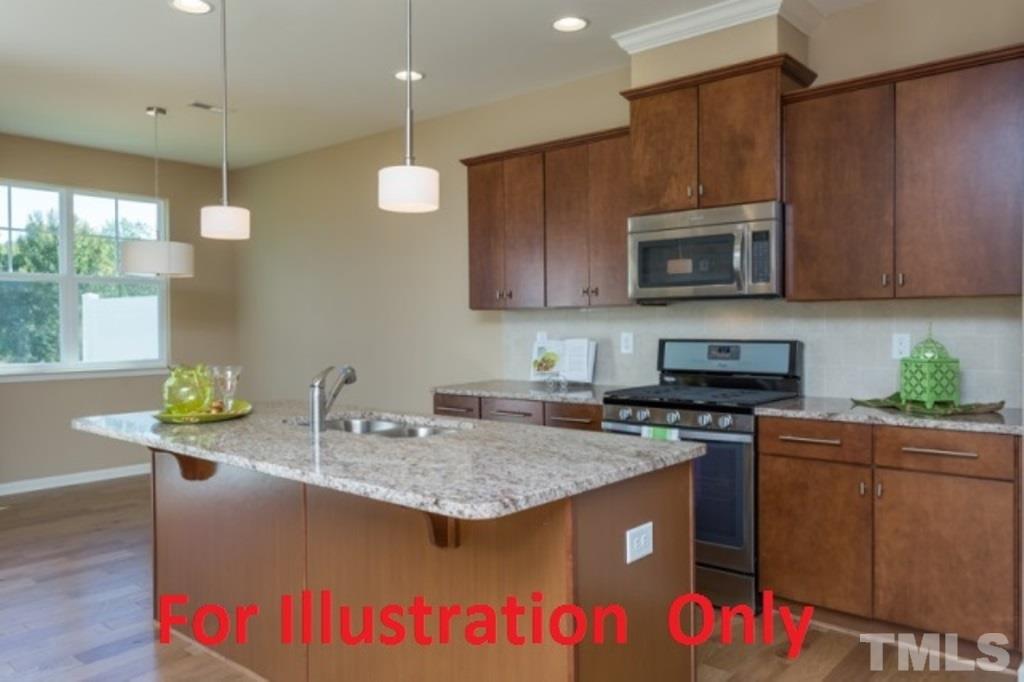 205 Zante Currant Road Durham, NC 27703 - Photo 3 of 25 a kitchen with kitchen island granite countertop a sink a counter top space appliances and cabinets
