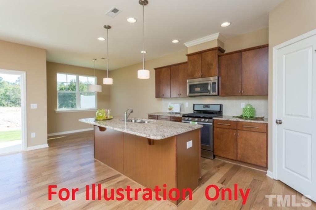 205 Zante Currant Road Durham, NC 27703 - Photo 4 of 25 a kitchen with granite countertop a sink and a stove top oven