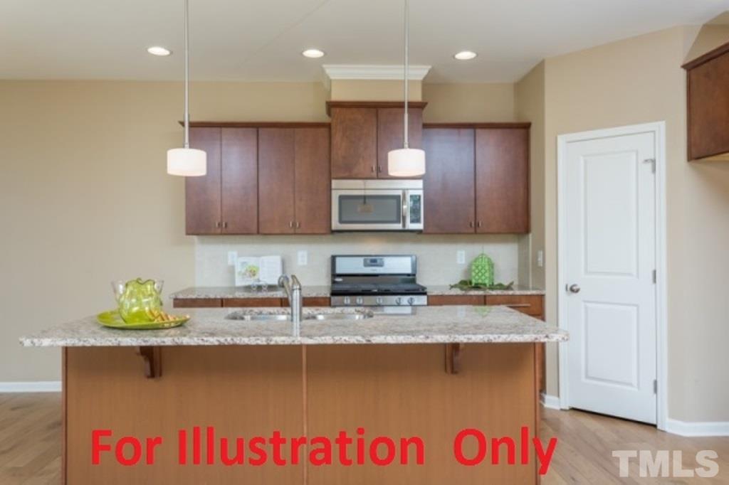 205 Zante Currant Road Durham, NC 27703 - Photo 5 of 25 a kitchen with granite countertop a sink a stove and cabinets