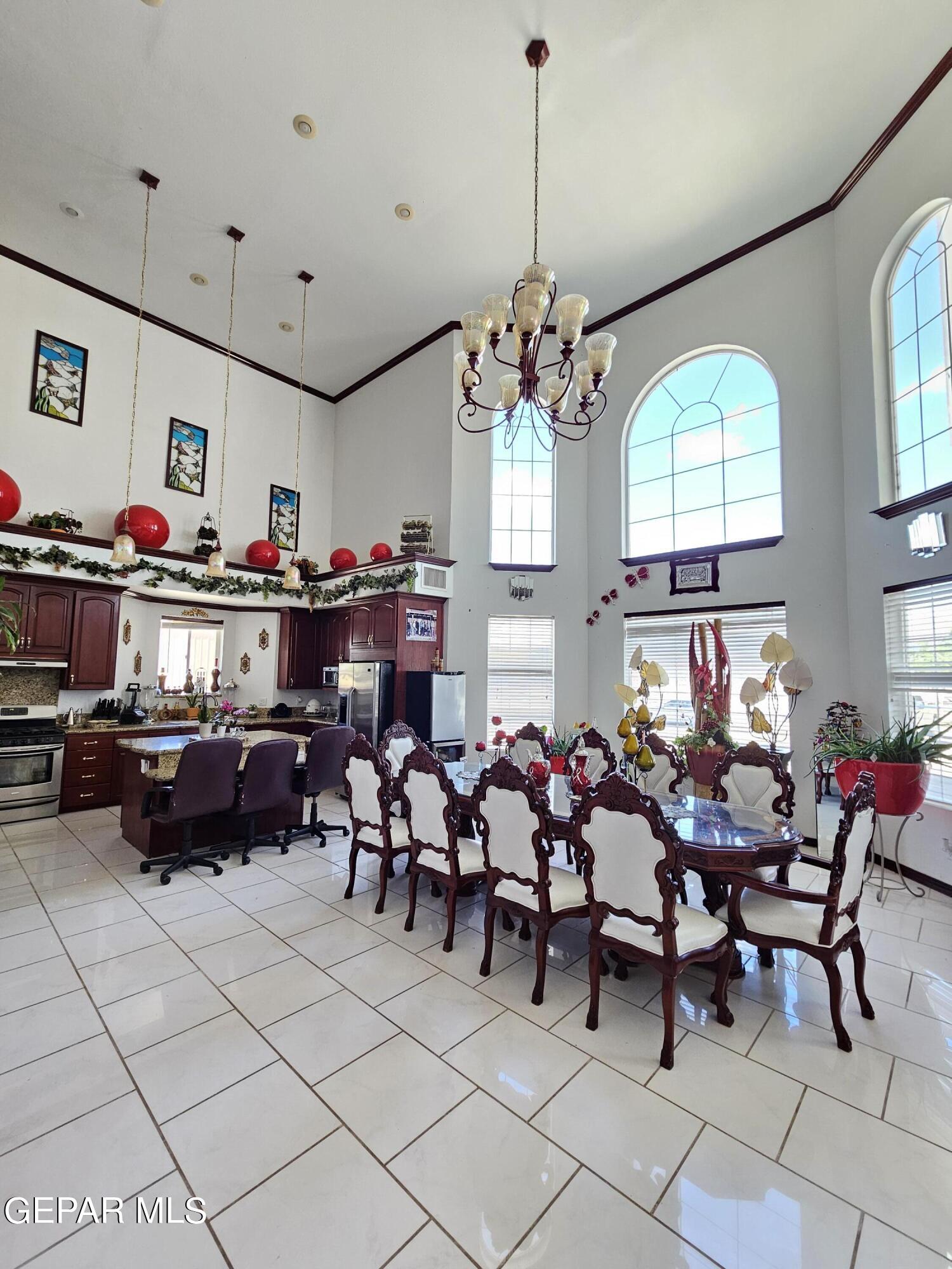6651 Strahan Road El Paso, TX 79932 - Photo 32 of 60 a view of a dining room with furniture and chandelier