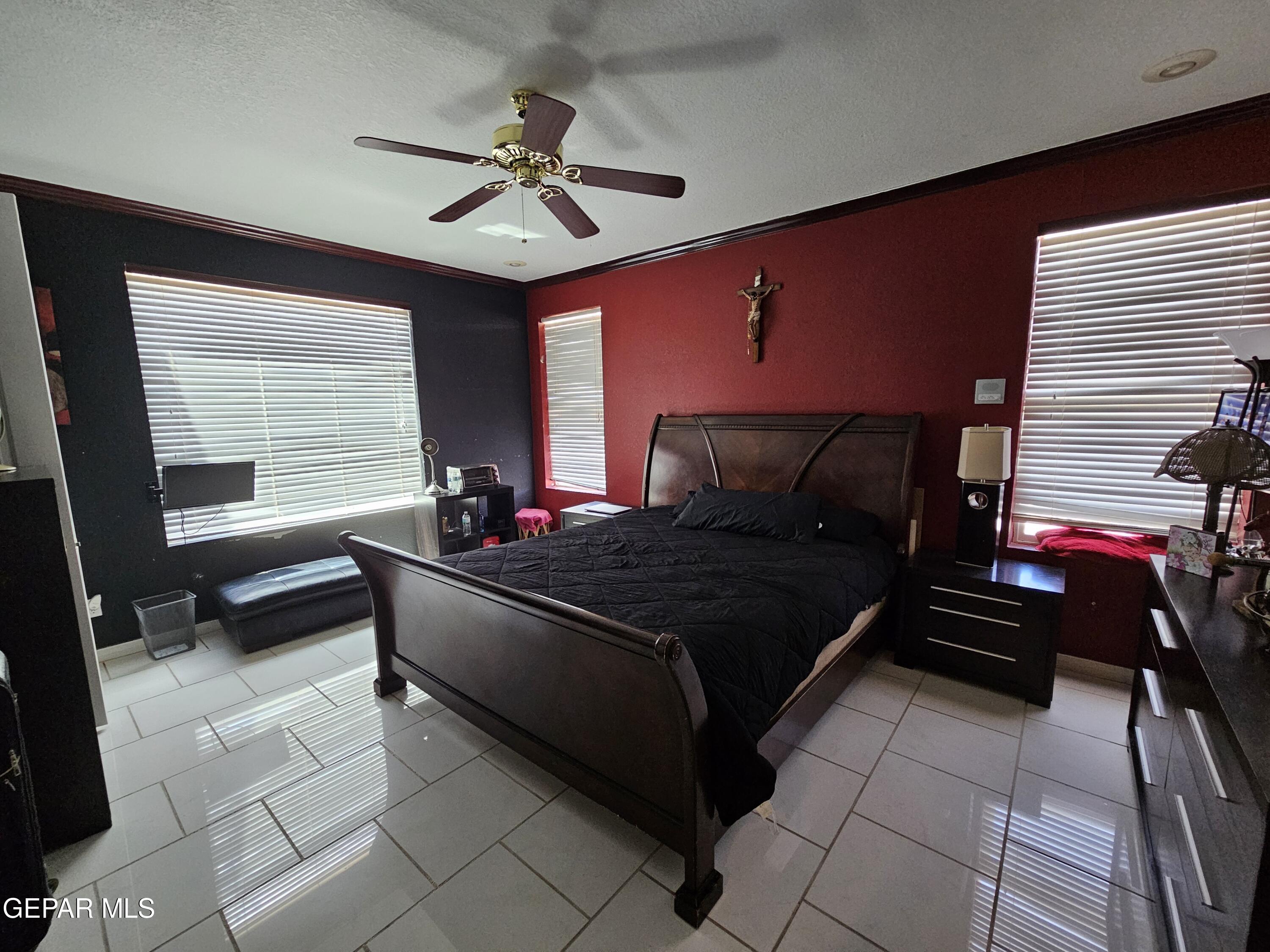 6651 Strahan Road El Paso, TX 79932 - Photo 39 of 60 a bedroom with a bed and a chandelier