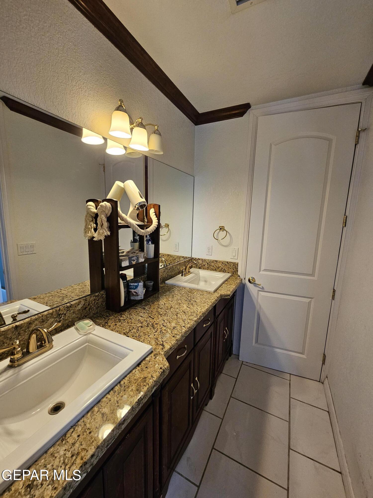 6651 Strahan Road El Paso, TX 79932 - Photo 41 of 60 a kitchen with a sink and a refrigerator