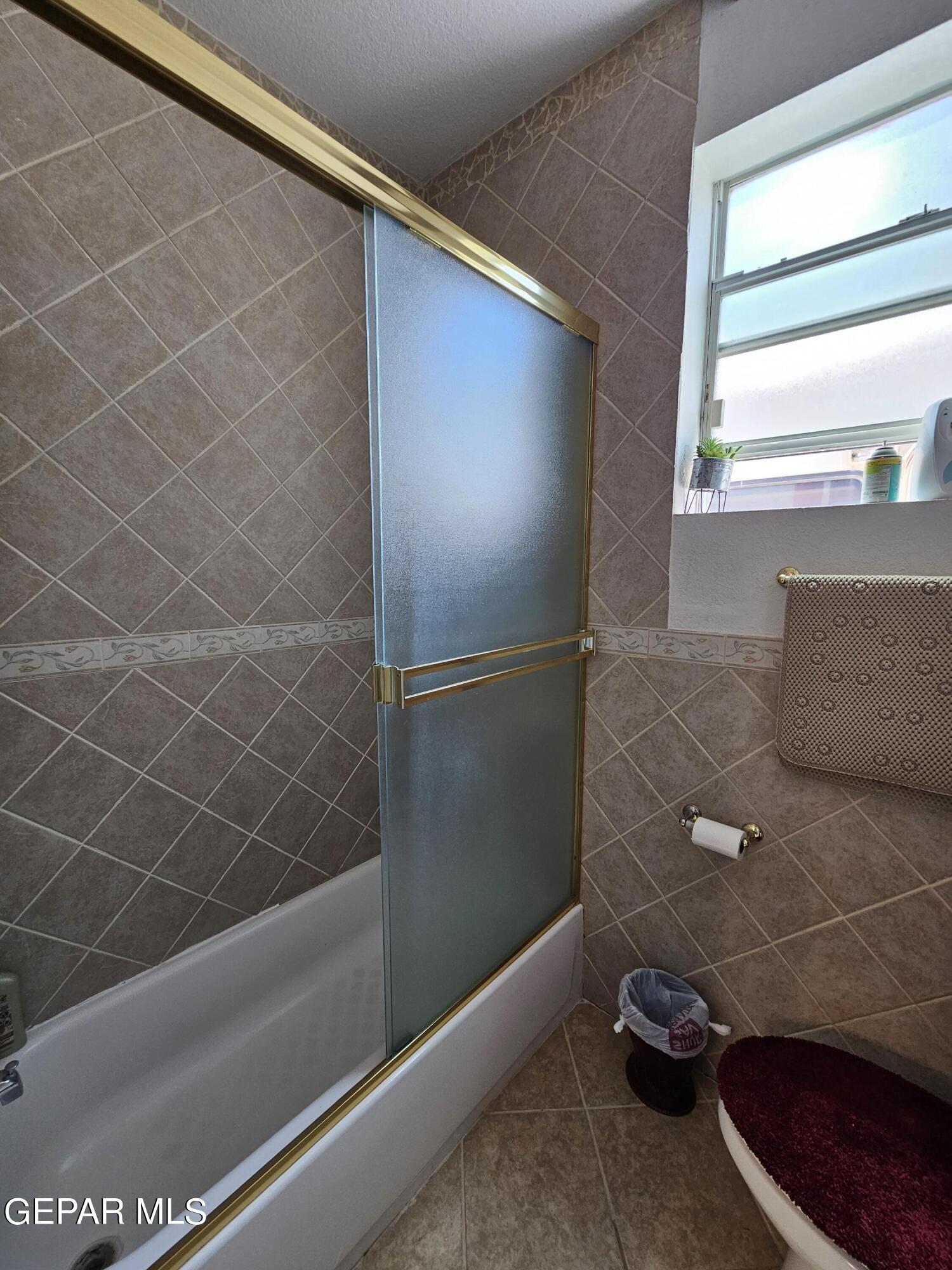 6651 Strahan Road El Paso, TX 79932 - Photo 42 of 60 a bathroom with a shower and a toilet