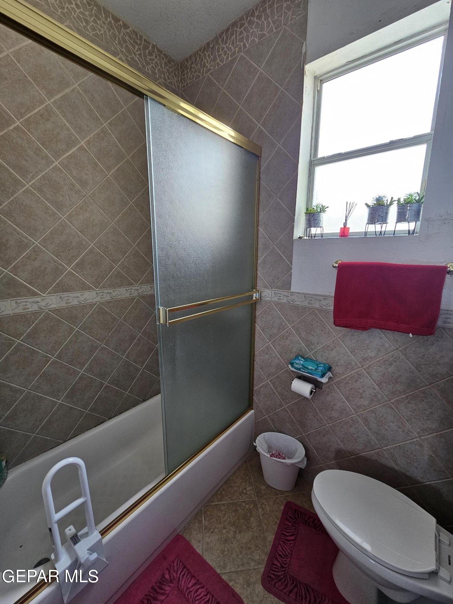 6651 Strahan Road El Paso, TX 79932 - Photo 46 of 60 a bathroom with a toilet and a shower