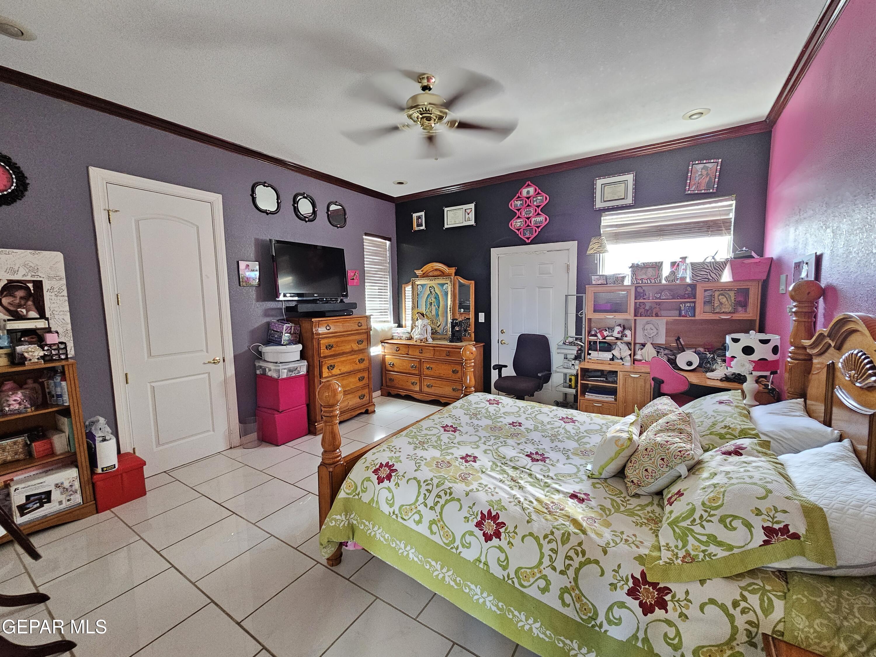 6651 Strahan Road El Paso, TX 79932 - Photo 48 of 60 a bedroom with bed and a chandelier