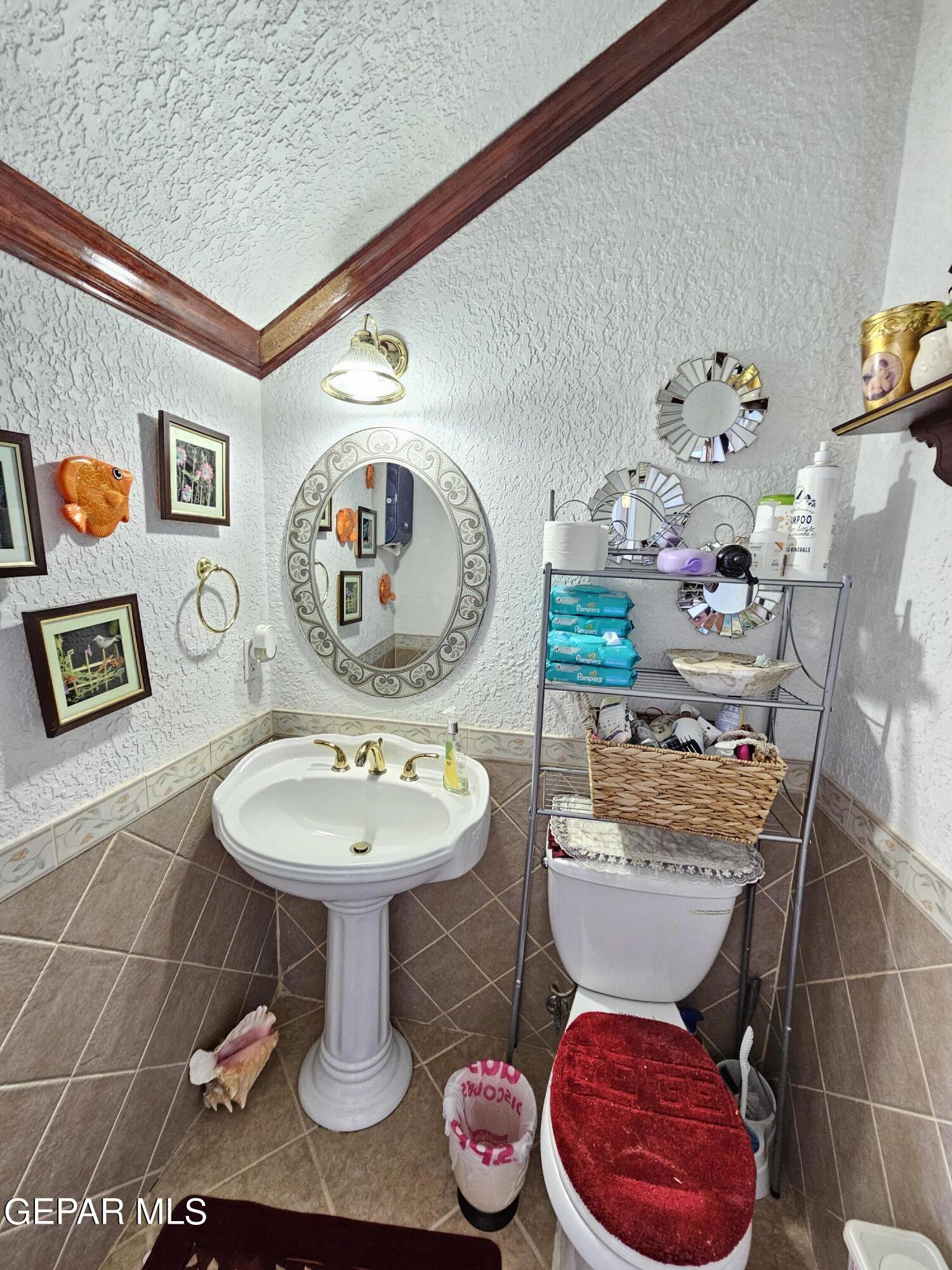 6651 Strahan Road El Paso, TX 79932 - Photo 49 of 60 a bathroom with a sink mirror and toilet