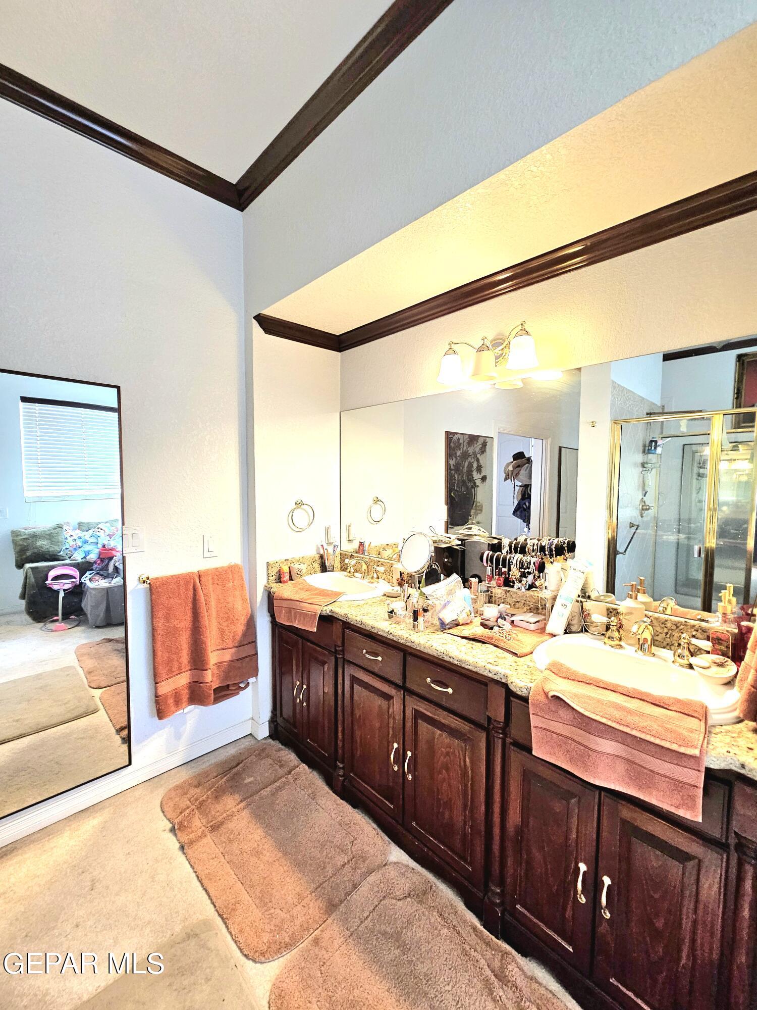 6651 Strahan Road El Paso, TX 79932 - Photo 55 of 60 a large bathroom with a double vanity sink and a mirror