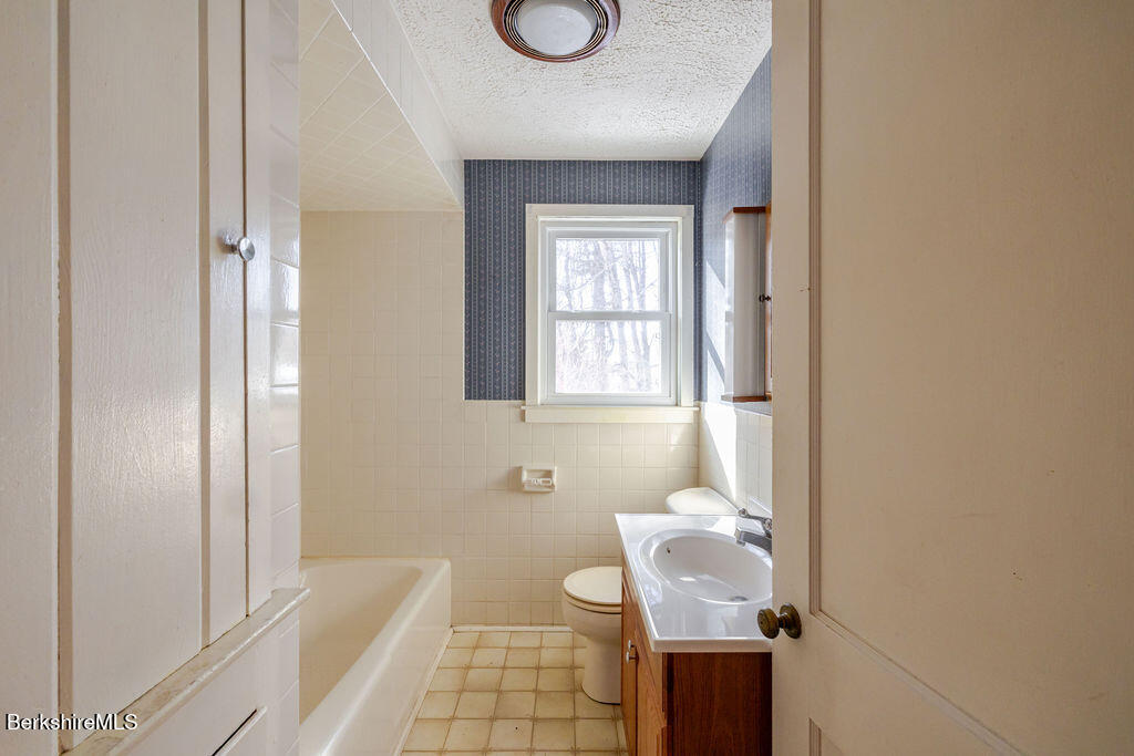 470 Main Road Monterey, MA 01245 - Photo 12 of 44 a bathroom with a toilet a sink and mirror