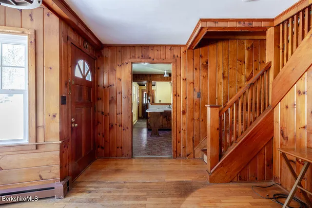 a view of an entryway with wooden floor and stairs