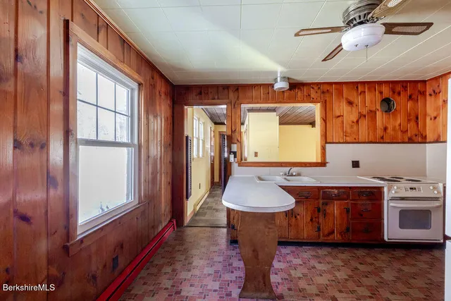 a kitchen with a stove a sink and a refrigerator