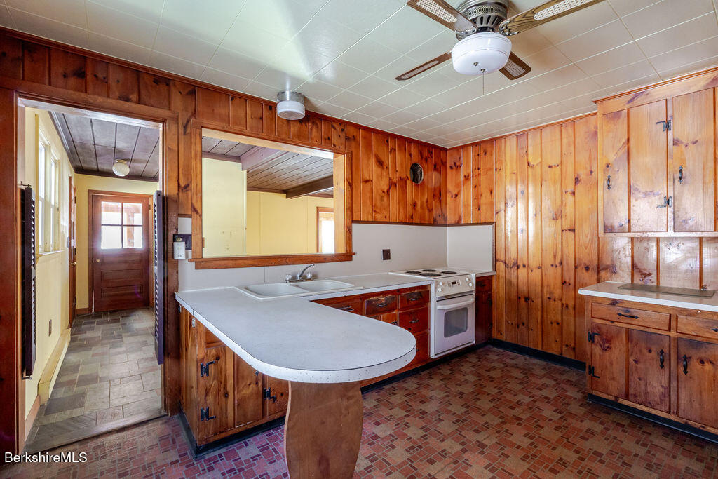 470 Main Road Monterey, MA 01245 - Photo 16 of 44 a kitchen with a stove a sink and a refrigerator