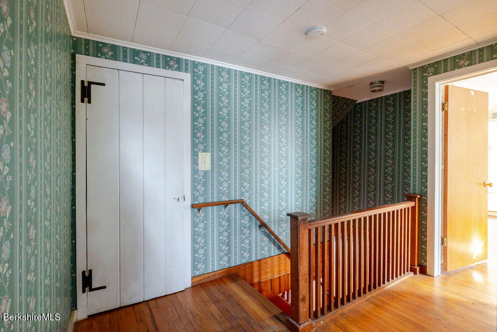 470 Main Road Monterey, MA 01245 - Photo 31 of 44 a view of a hallway with wooden floor and staircase