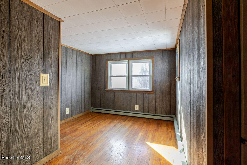 470 Main Road Monterey, MA 01245 - Photo 34 of 44 an empty room with wooden floor and windows