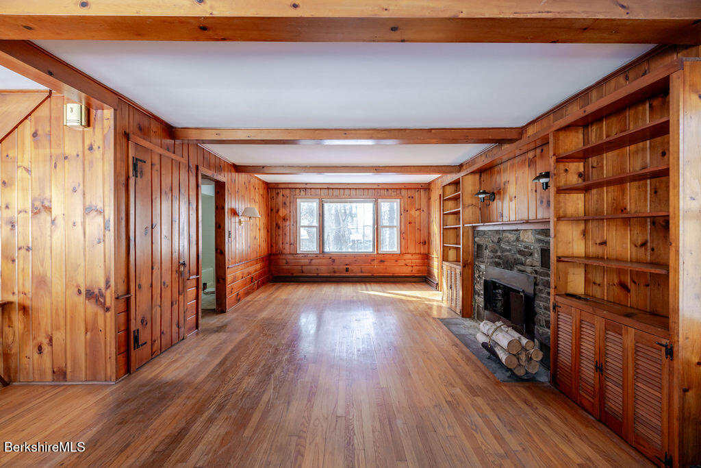 470 Main Road Monterey, MA 01245 - Photo 6 of 44 a view of an empty room with wooden floor fireplace and a window