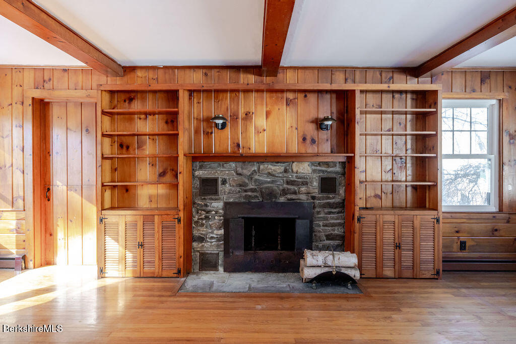 470 Main Road Monterey, MA 01245 - Photo 7 of 44 a living room with a fireplace cabinet and a fireplace