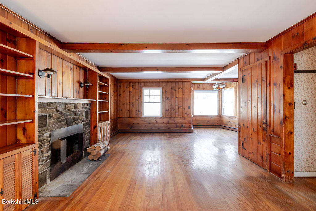 470 Main Road Monterey, MA 01245 - Photo 8 of 44 wooden floor in an empty room with a fireplace