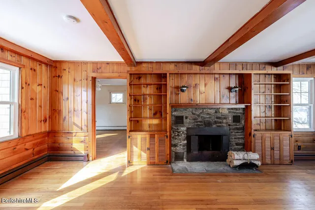 a living room with a fireplace and a floor to ceiling window