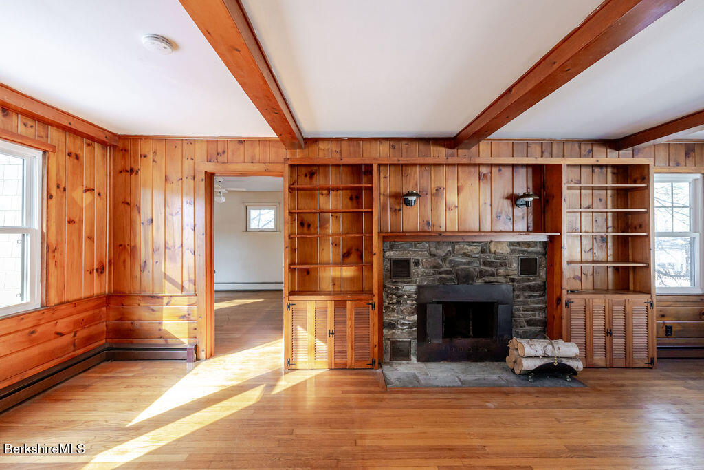 470 Main Road Monterey, MA 01245 - Photo 9 of 44 a living room with a fireplace and a floor to ceiling window