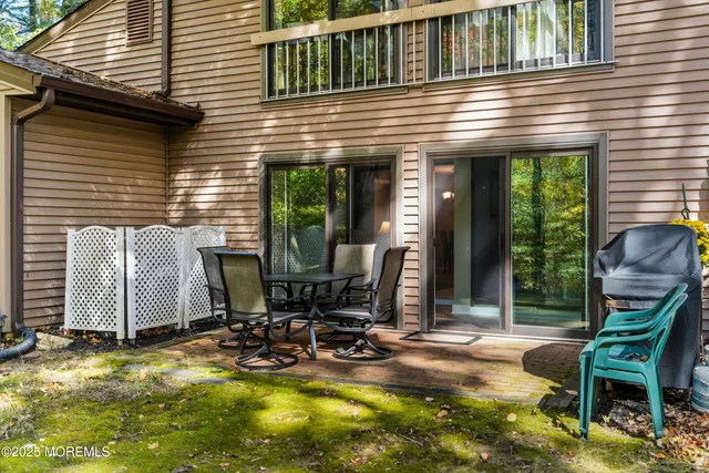 a view of a house with backyard porch and sitting area