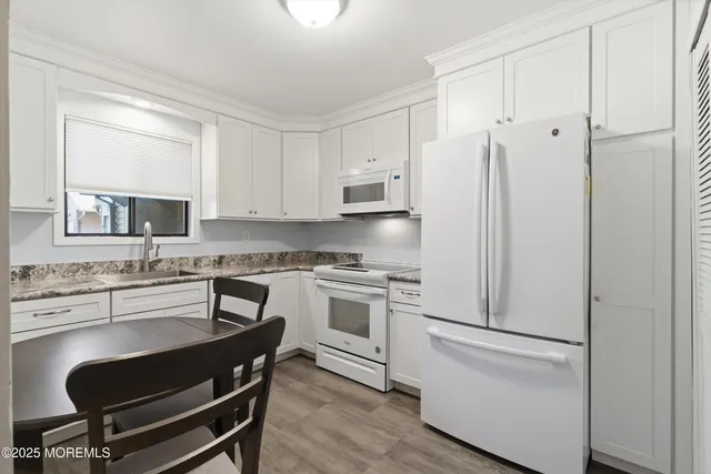 a kitchen with stainless steel appliances a refrigerator stove and sink