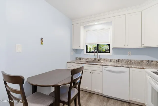 a kitchen with a sink cabinets and chair