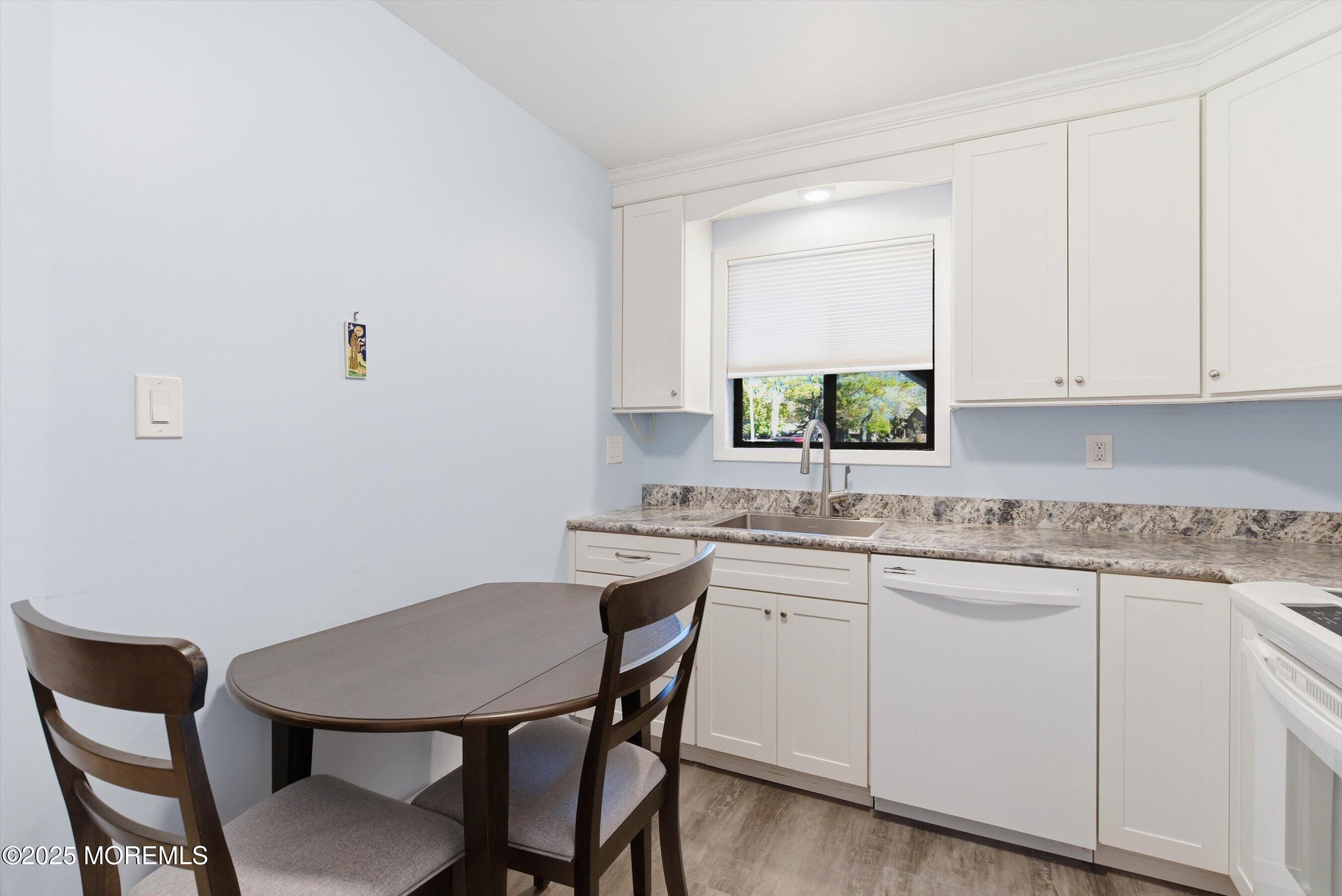 32 Ellsworth Court Red Bank, NJ 07701 - Photo 4 of 32 a kitchen with a sink cabinets and chair