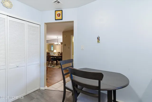 a view of a room that has a table and chairs in it