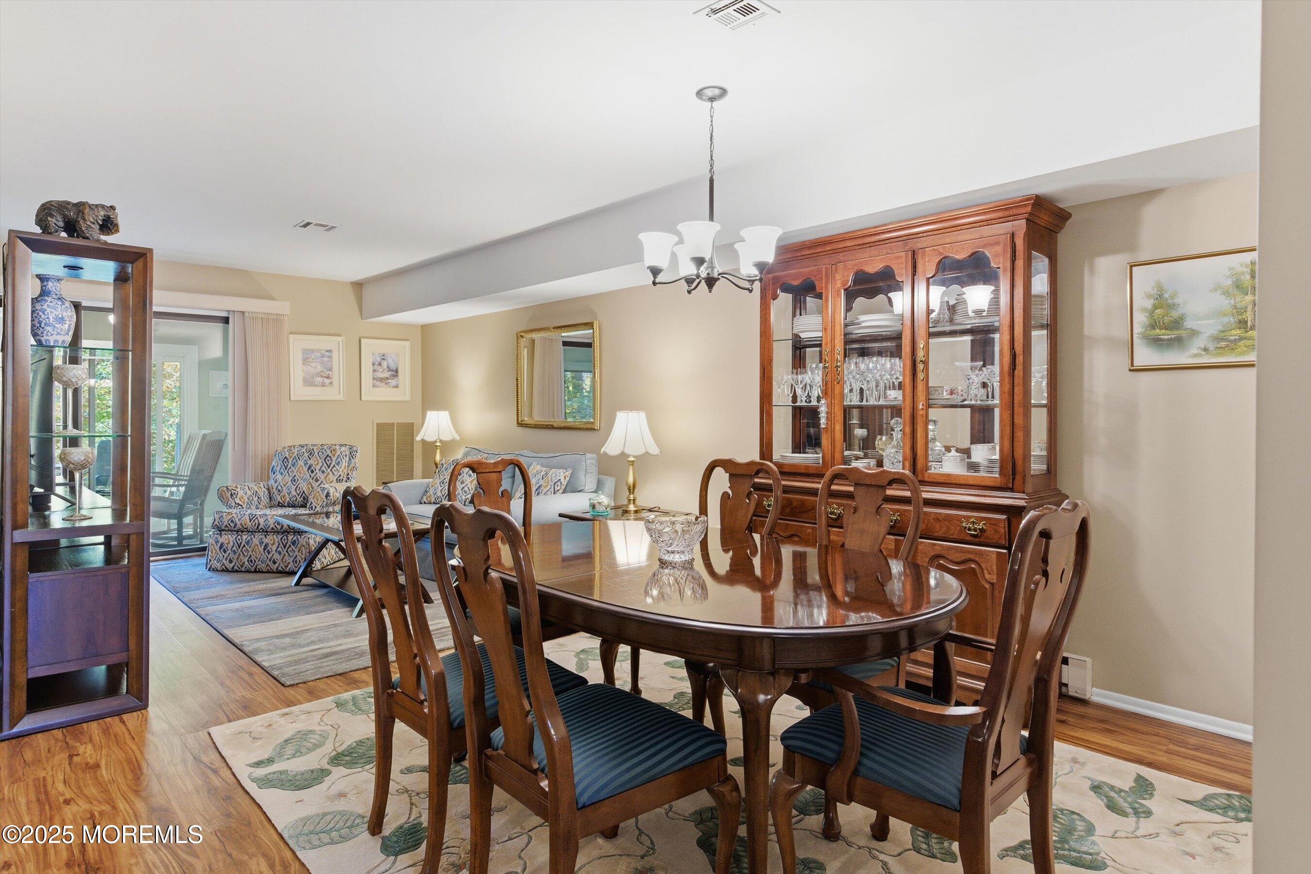 32 Ellsworth Court Red Bank, NJ 07701 - Photo 7 of 32 a view of a dining room and livingroom with furniture wooden floor a chandelier