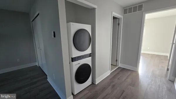 a view of a hallway with washer and dryer