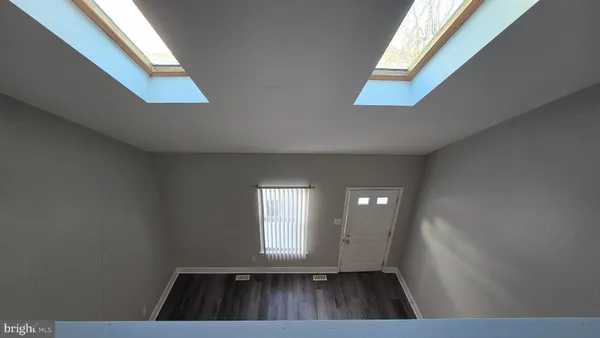 a view of kitchen and hall with wooden floor