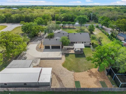 an aerial view of a house with a yard