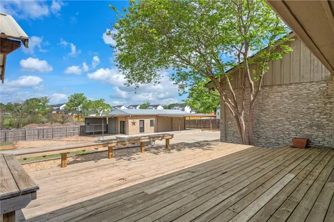 a view of a house with wooden deck