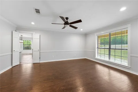 a view of a livingroom with a ceiling fan and window