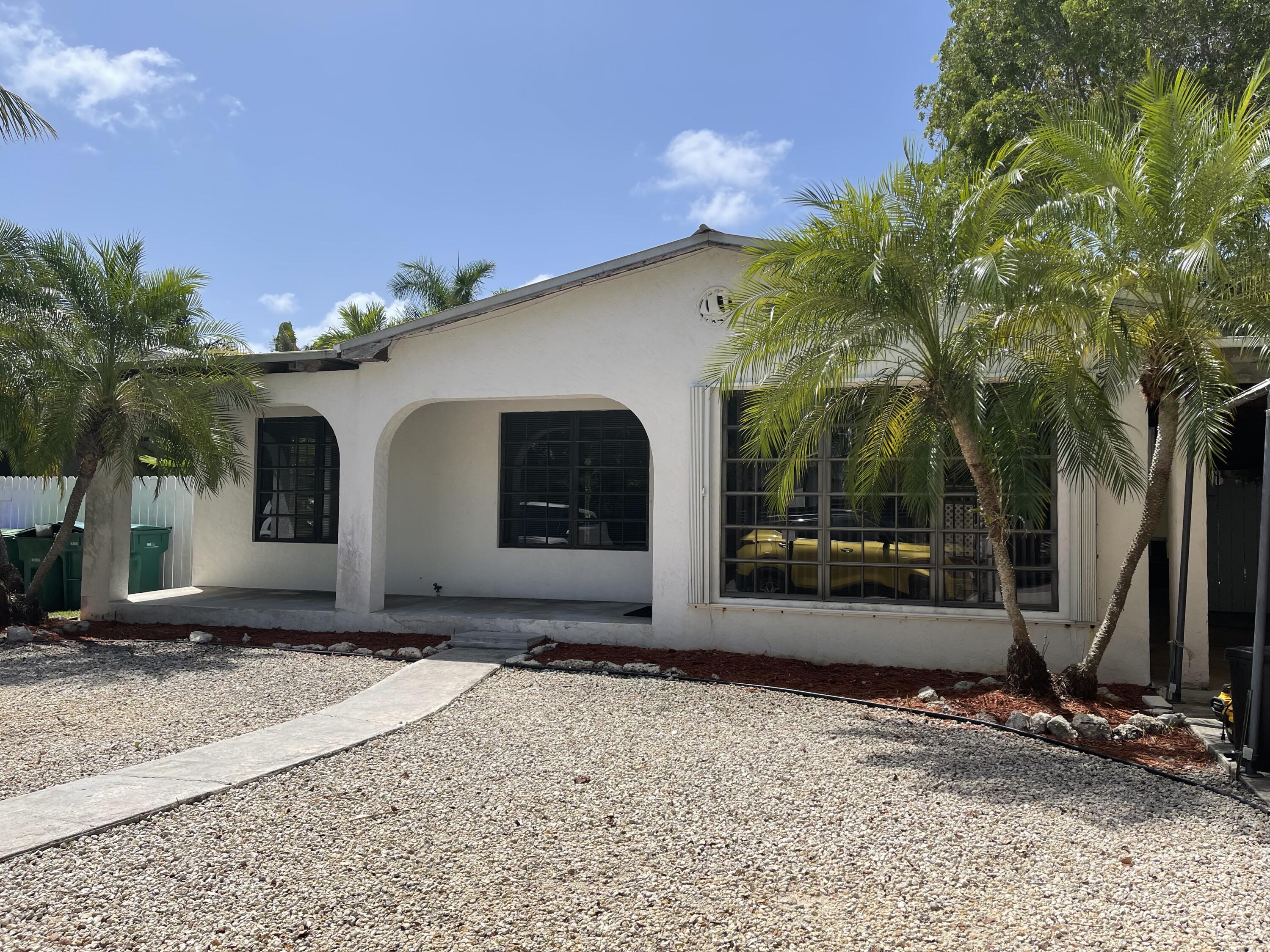 1610 Laird Street Key West, FL 33040 - Photo 1 of 20 a front view of a house with a yard