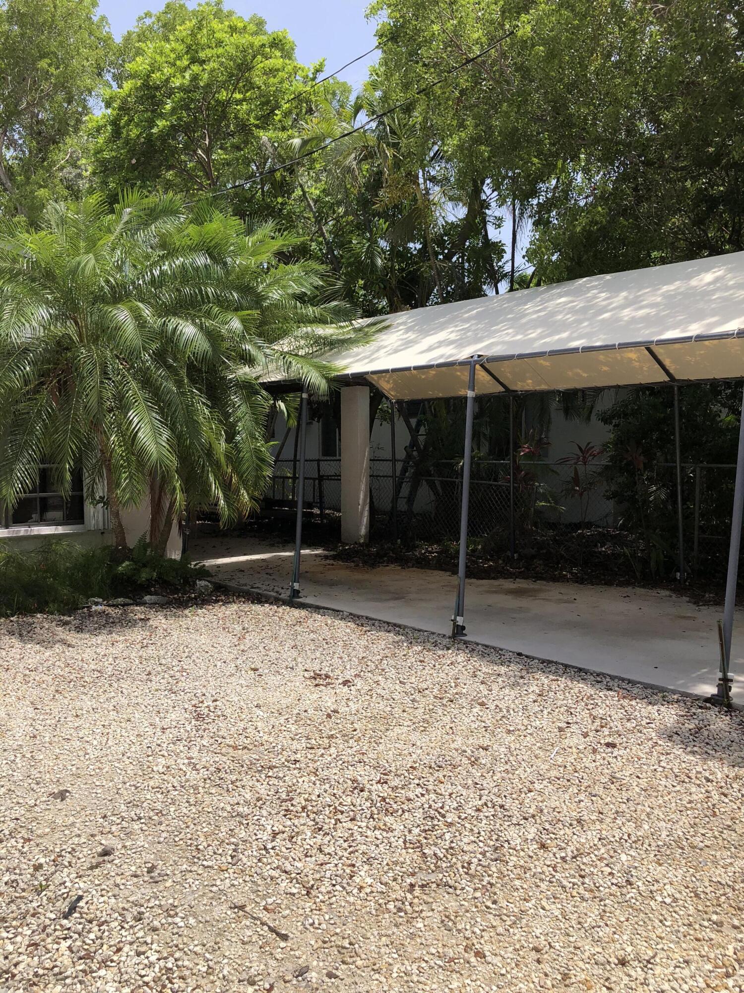 1610 Laird Street Key West, FL 33040 - Photo 16 of 20 a backyard of a house with basket ball court and outdoor seating
