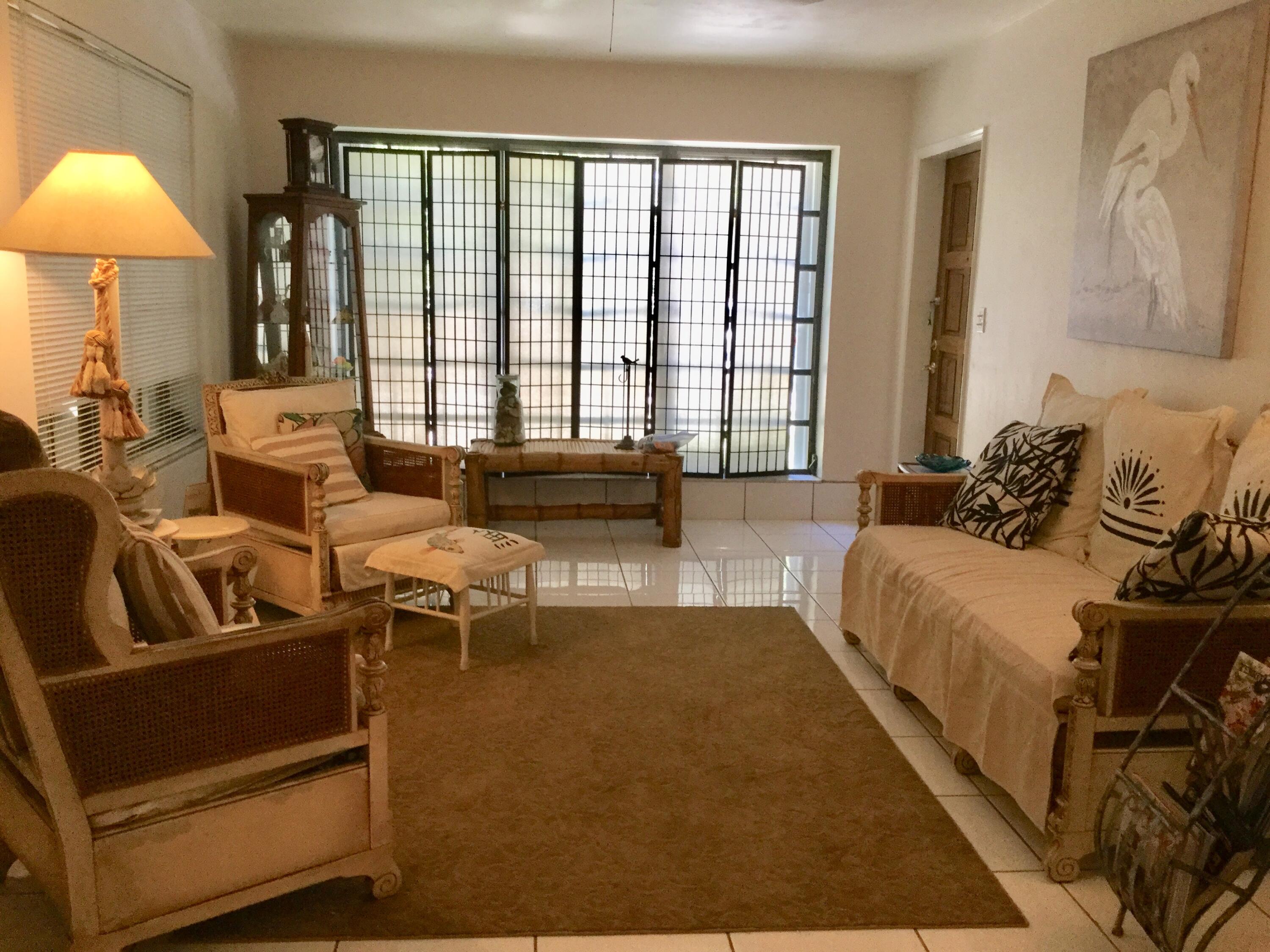 1610 Laird Street Key West, FL 33040 - Photo 3 of 20 a spacious bedroom with a bed and glass windows