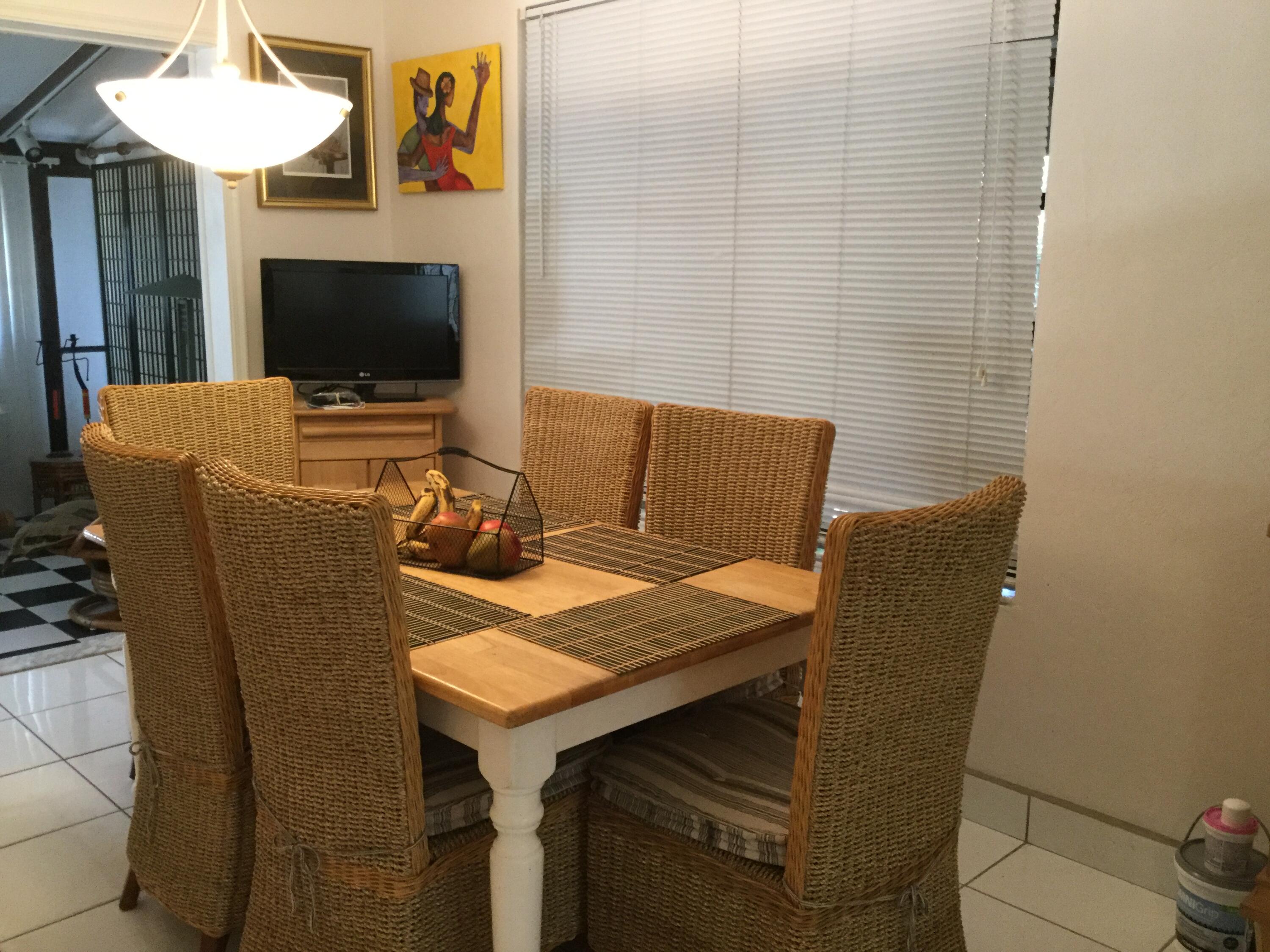 1610 Laird Street Key West, FL 33040 - Photo 4 of 20 a view of a dining room with furniture and a flat screen tv