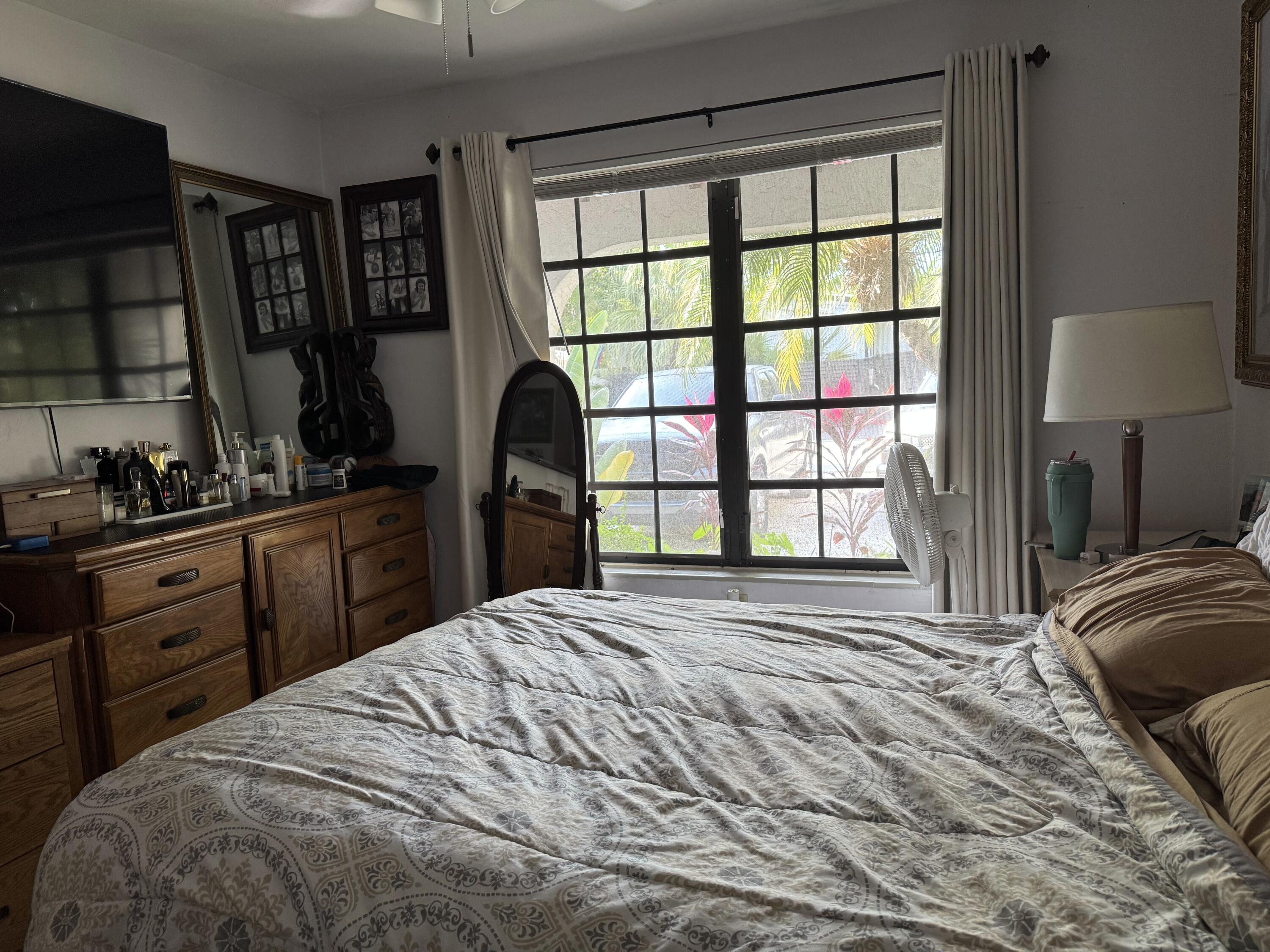 1610 Laird Street Key West, FL 33040 - Photo 5 of 22 a bedroom with a bed a window and dresser