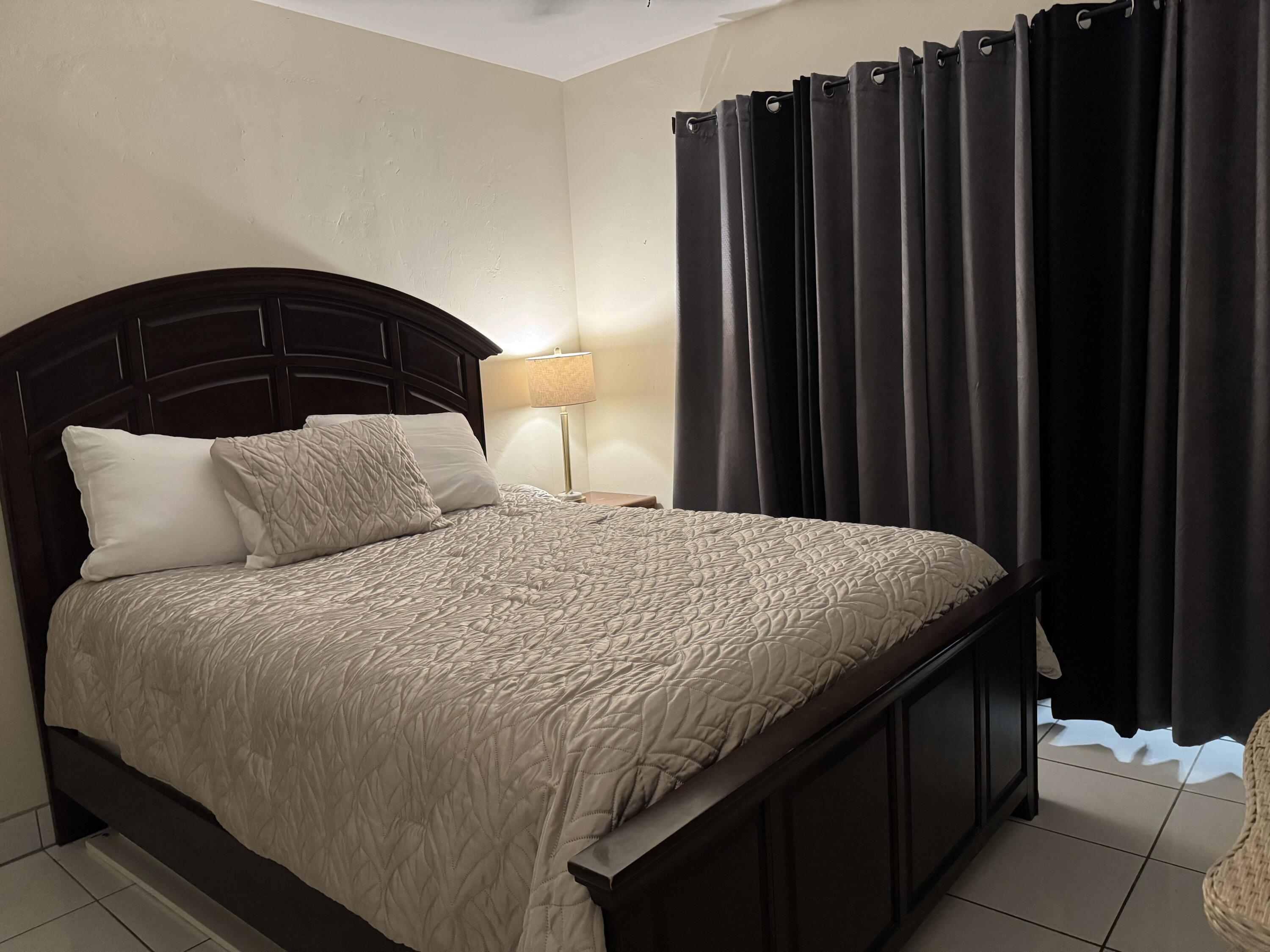 1610 Laird Street Key West, FL 33040 - Photo 6 of 22 a bedroom with a bed and wooden floor