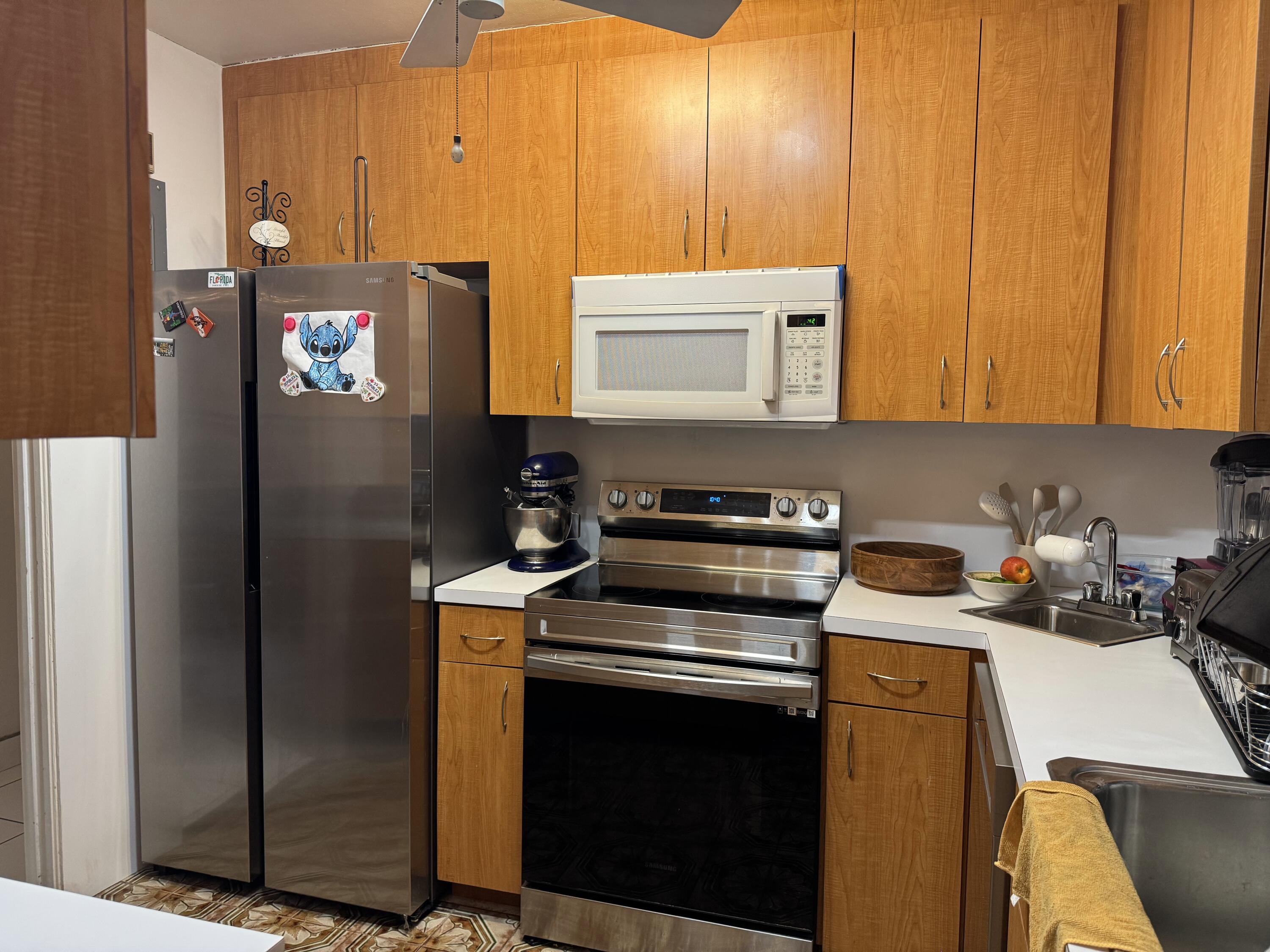 1610 Laird Street Key West, FL 33040 - Photo 6 of 20 a kitchen with a refrigerator stove and sink