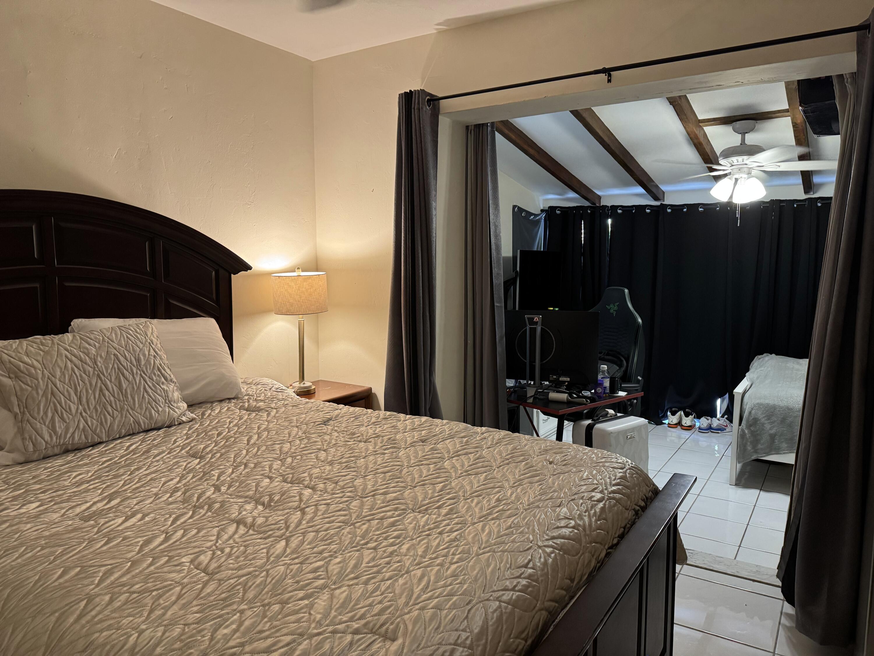 1610 Laird Street Key West, FL 33040 - Photo 8 of 22 a bedroom with a bed window and walk in closet