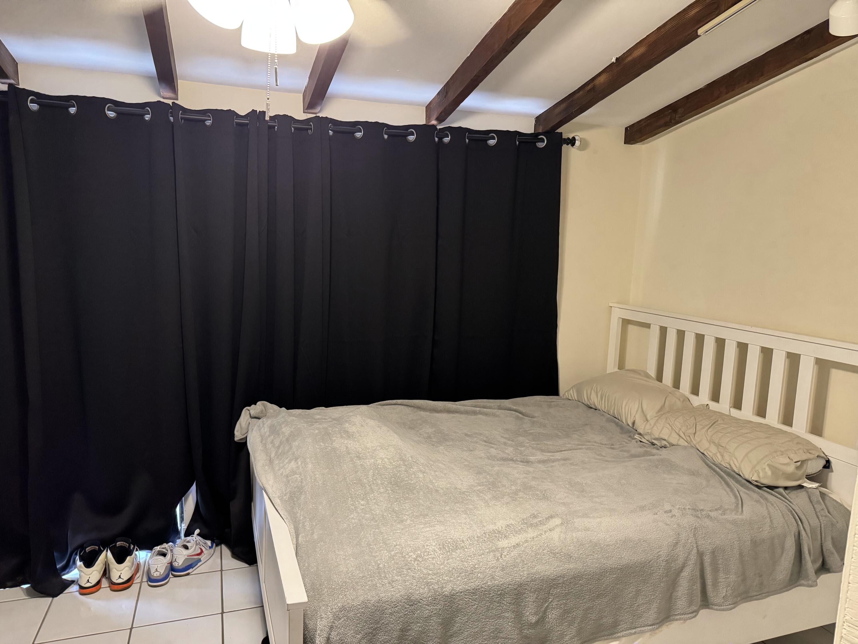 1610 Laird Street Key West, FL 33040 - Photo 10 of 22 a bed sitting in a bedroom next to a cabinet