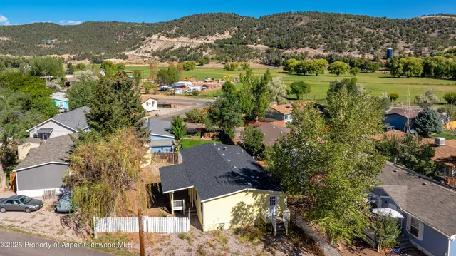 an aerial view of residential houses with outdoor space and river