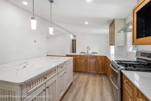 a kitchen with a sink and a stove top oven